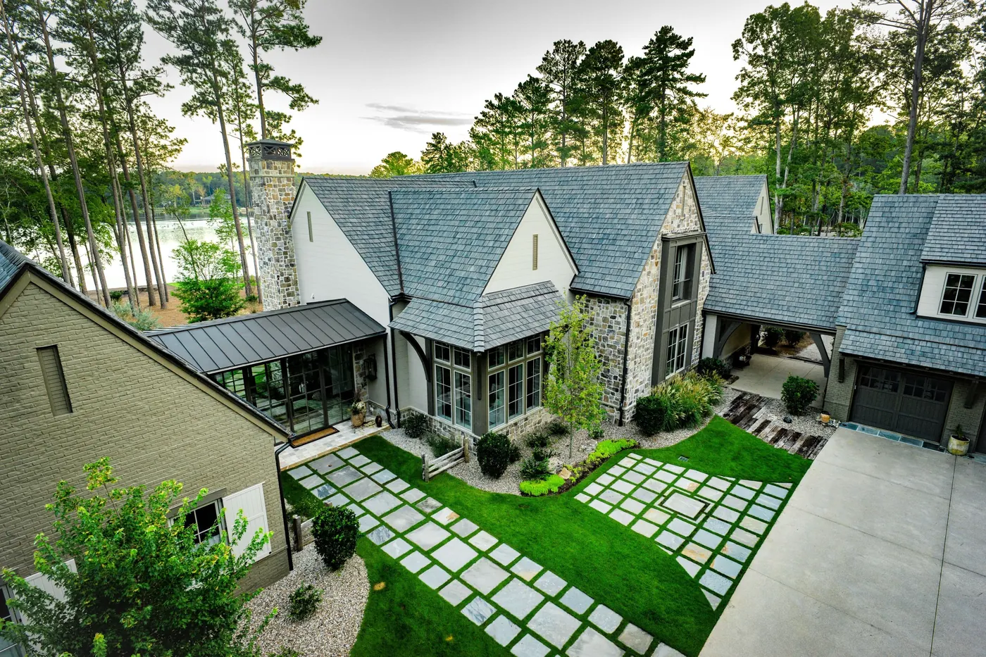 Stone and shingle-style home with a dimensional Brava Old World Slate roof