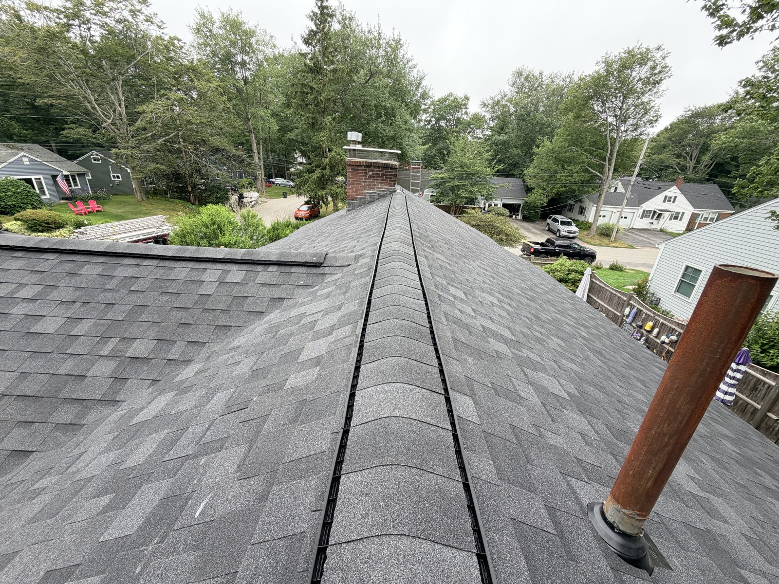 Finished architectural shingle roof with straight ridge line