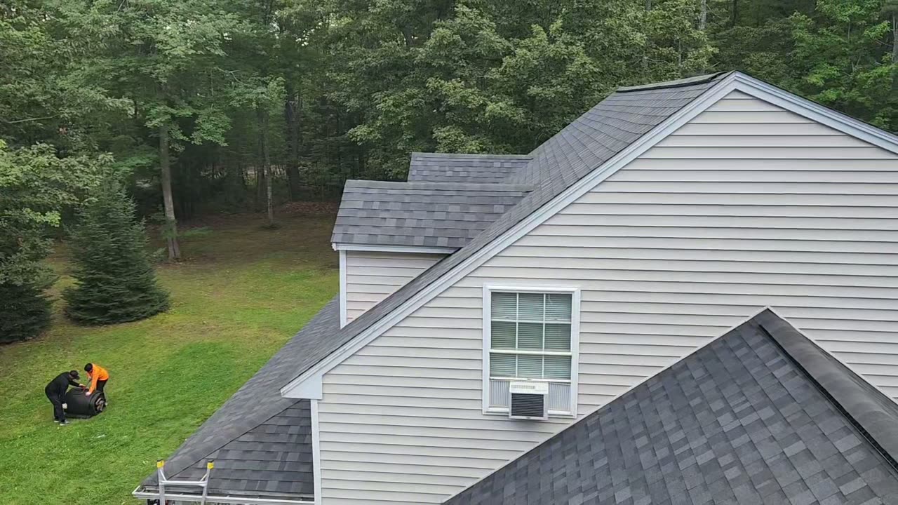 Video pass over the finished shingle roof and gable of the Wells home — Wells, ME