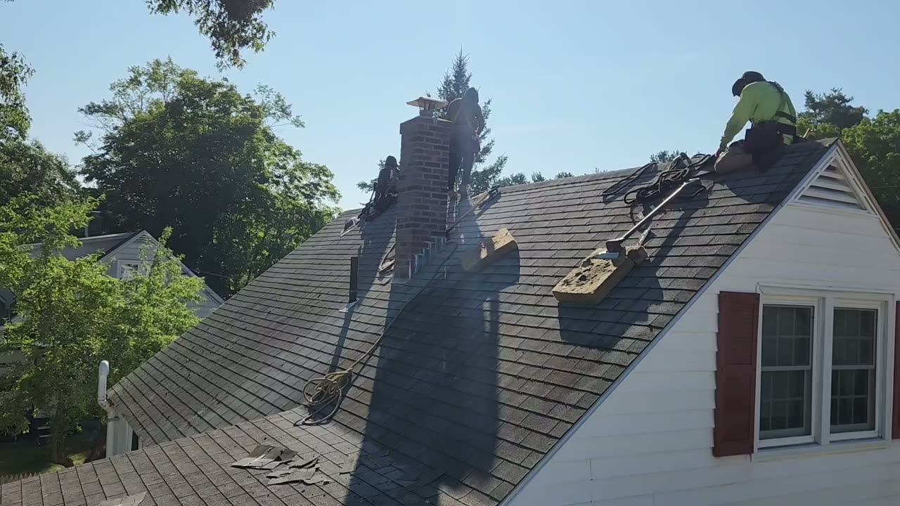 Video of the crew tearing off old shingles along the ridge of the Brunswick home — Brunswick, ME