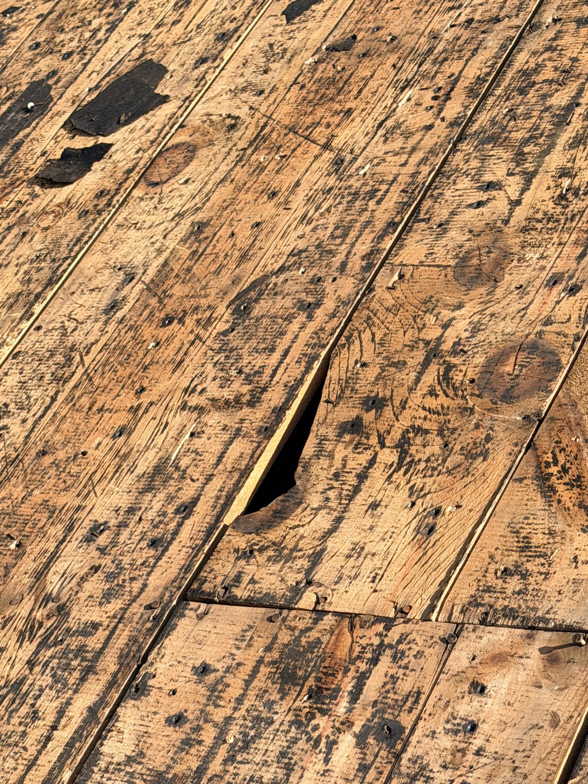 Close-up of gapped and split plank sheathing boards